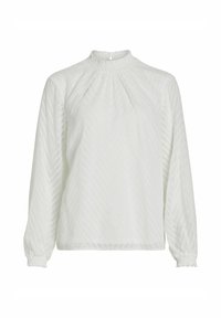 Blusa bianca a maniche lunghe con colletto alto, motivo a spina di pesce testurizzato e dettagli arricciati ai polsini e al colletto.
