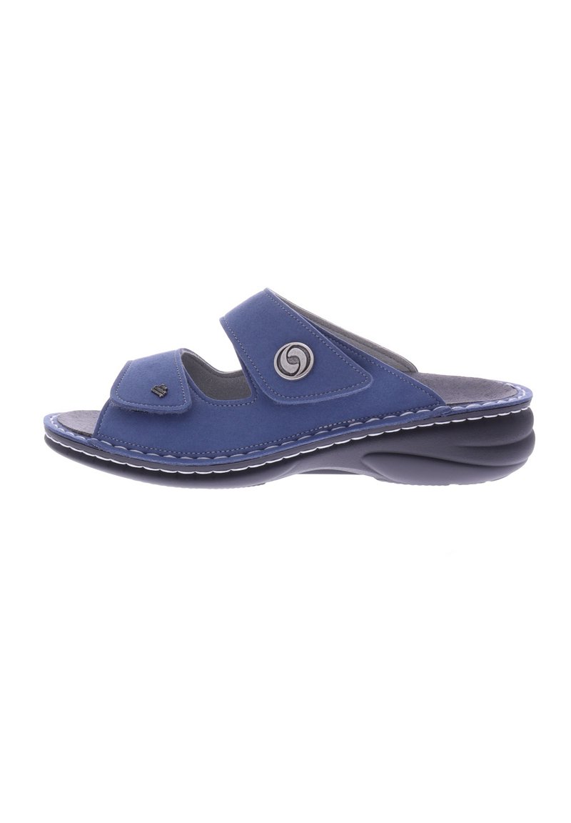 Blue slide sandal with adjustable velcro straps, cushioned footbed, and rubber sole. Features a circular logo on the side and contrast stitching.