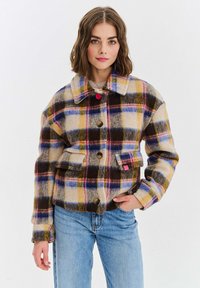 Kostkovaná sako z vlny s vícebarevnými vzory v hnědé, žluté, modré a růžové. Má límec a zapínání na knoflíky.