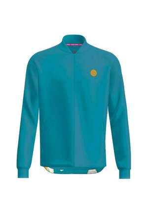 Tealfarbener Full-Zip-Jacke mit langen Ärmeln, Rundhalsausschnitt, strukturierten Schulterpaneelen und kleinem gelben runden Logo auf der Brust.