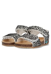 Zwart-witte sandalen met stippen, voorzien van twee verstelbare banden, een kurken voetbed, rubberen loopzool en een turkoois accent op de hak.