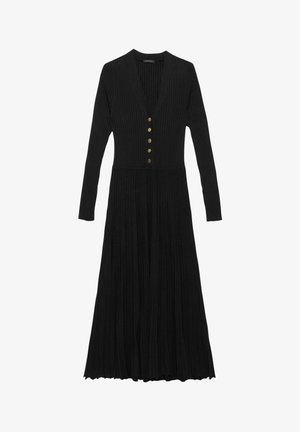 Zwarte geribbelde gebreide jurk met lange mouwen, diepe V-hals en vijf gouden knopen die over de voorkant lopen; heeft een geplooide rok.