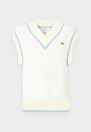 Baltas ribotas be rankovių megztinis su V formos iškirpte, dekoruotas mėlynomis ir geltonomis juostelėmis aplink iškirptę ir apatinę kraštą; mažas žalias logotipas ant krūtinės.