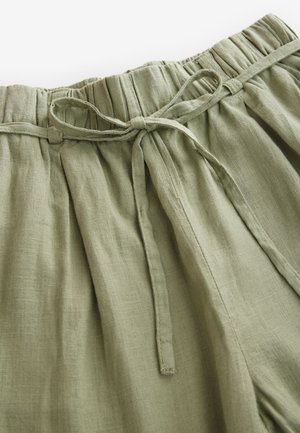 Light olive green, linen blend pants with a gathered elastic waistband, drawstring tie, and soft texture; features subtle pleats.