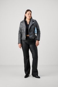 Gray leather motorcycle jacket with silver hardware, black crop top, black flared pants, and black shoes; holding a blue bag.