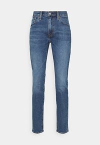 Ljust blå denimjeans med raka ben, femficksdesign och knäppning med knapp. Har subtila blekningar och sydda detaljer.