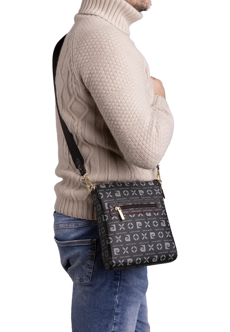 Borsa a tracolla nera con motivo geometrico, dotata di tasca con zip anteriore e tracolla regolabile. Realizzata in materiale resistente, design strutturato.