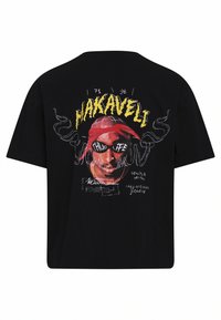 Svart bomullströja med en grafik av en figur med röd bandana, gul text "MAKAVELI," och olika vita skisser på baksidan.