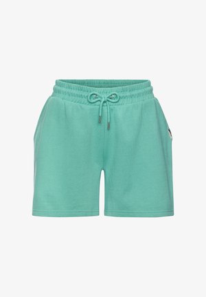 Teal cotton shorts with elastic waistband and drawstring, side pockets, and small fabric brand tag on right side.