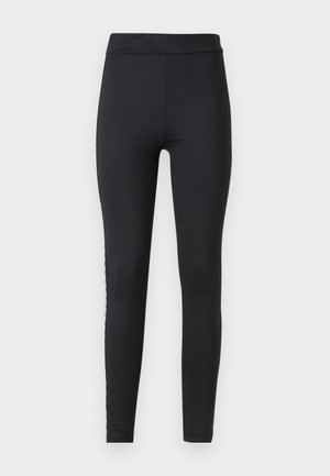 Leggings neri realizzati in tessuto elasticizzato con una texture liscia, dotati di una cintura larga e una striscia decorativa laterale.