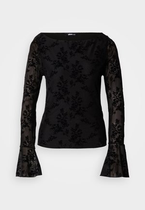 Top negru cu mânecă lungă din material transparent cu model floral pe mâneci și corp, având manșete evazate și un decolteu larg rotunjit.