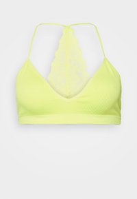 Bralette amarelo canelado com um decote V profundo e alças ajustáveis, apresentando um design de costas rendadas para um detalhe e textura adicionais.