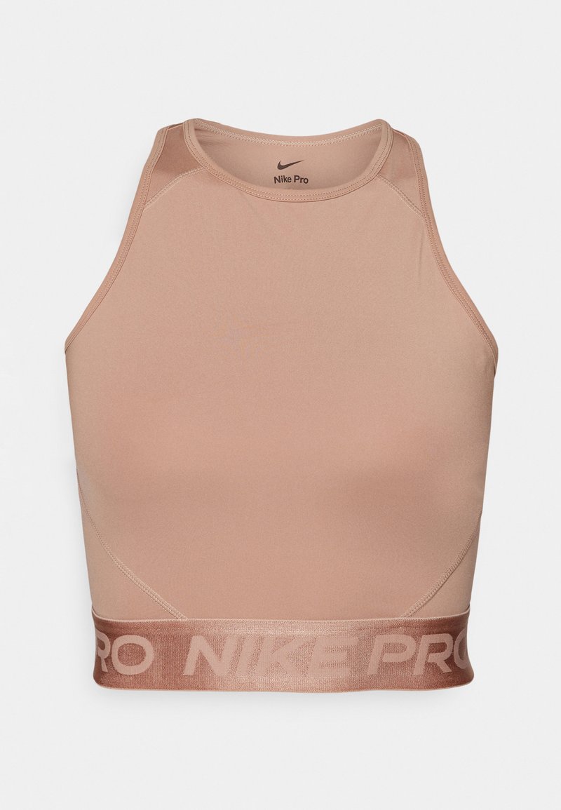 Nike Pro reggiseno sportivo in un morbido colore beige, caratterizzato da un design aderente, una texture liscia e un elastico con marchio sull'orlo.