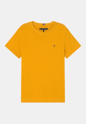 T-shirt jaune en coton à col rond avec manches courtes, présentant une petite écusson logo de la marque sur la poitrine et des détails de surpiqûres contrastantes.