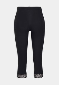 Leggings noirs au design ajusté avec un ourlet en dentelle. Fabriqués en matériau doux. Présente une texture lisse et soyeuse tout au long.
