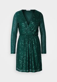 Robe mini à manches longues vert foncé avec col en V, style portefeuille et sequins brillants sur toute la surface, sur un fond uni.