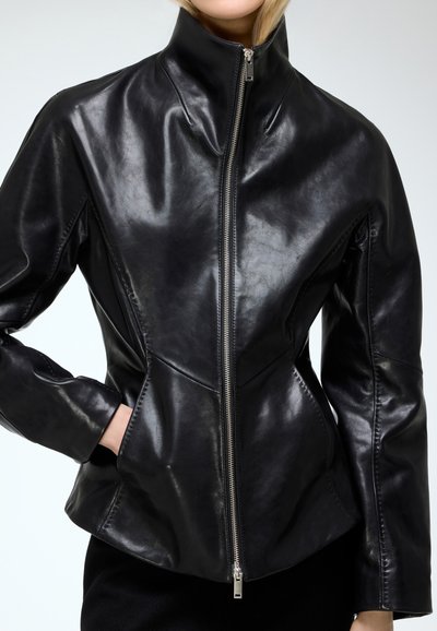 Black leather jacket with high collar, zippered front, fitted design, sleek texture, and tailored seams, featuring side pockets and smooth finish.
