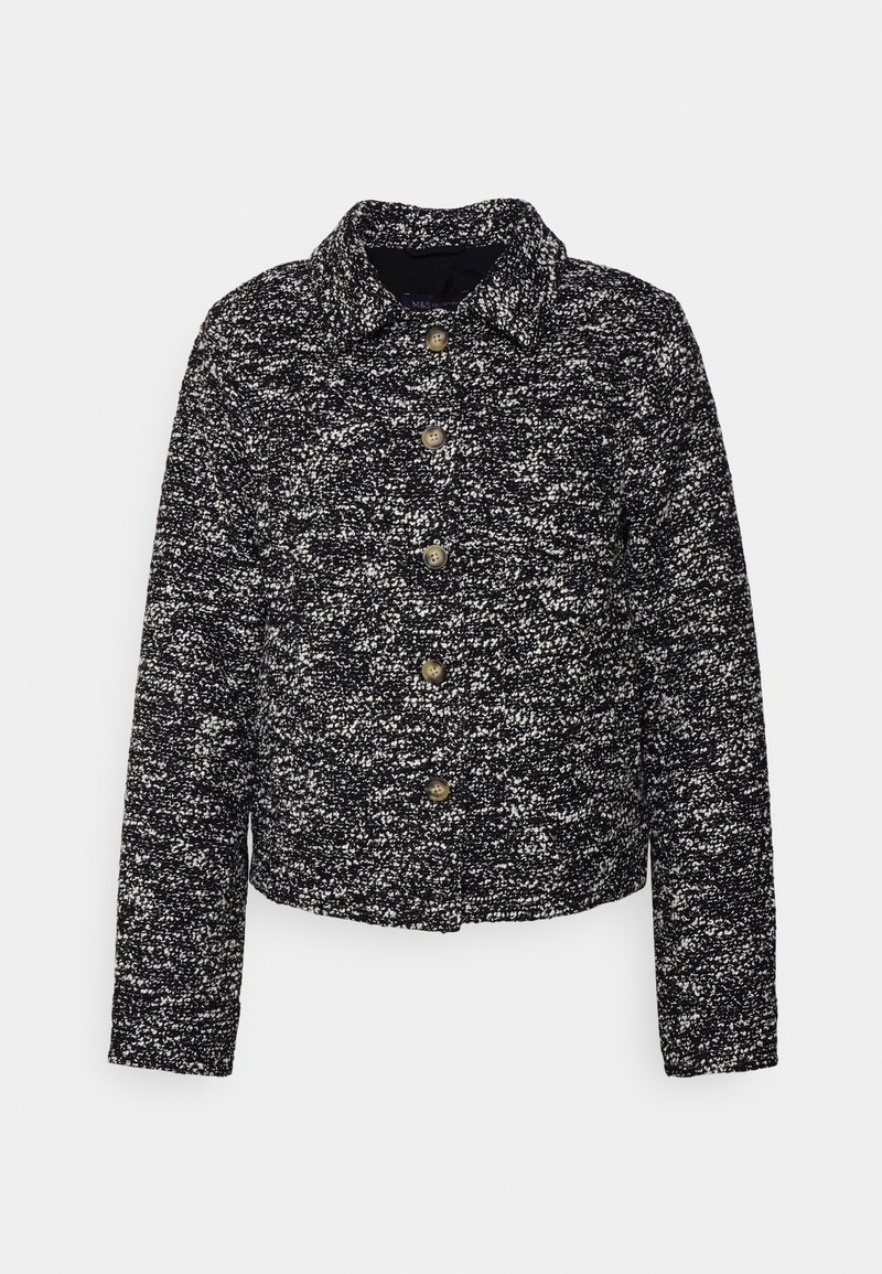 Schwarz-weiße gepunktete Jacke mit Kragen, Knopfverschluss und langen Ärmeln, aus gewebtem Stoff mit strukturierter Optik.