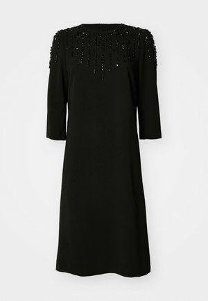 Black dress with a round neckline and three-quarter sleeves. The bodice features beaded accents arranged in a vertical pattern.