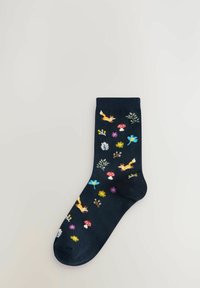 Dark blue socks featuring colorful patterns of foxes, flowers, and mushrooms. Made of soft material with a smooth texture.