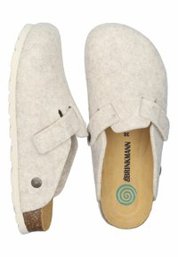Light beige felt slip-on clogs with adjustable strap, cork footbed, white sole, and branded insole with size 38.