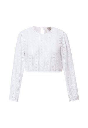 Blusa bianca in pizzo a maniche lunghe con motivi floreali, scollo rotondo, chiusura posteriore a occhiello e spalle leggermente arricciate.