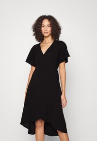 Black wrap dress with a V-neckline, short flutter sleeves, and a high-low hem. Made from soft fabric with a smooth texture.