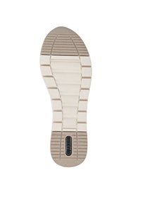 Schuhsohle in hellbeige mit strukturiertem Oberflächen, ausgestattet mit einem ausgeprägten Profilmuster und einem schwarzen Logo-Bereich.