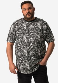 Short-sleeve black and white shirt featuring a palm leaf pattern, made from lightweight fabric; round neck design with a relaxed fit.