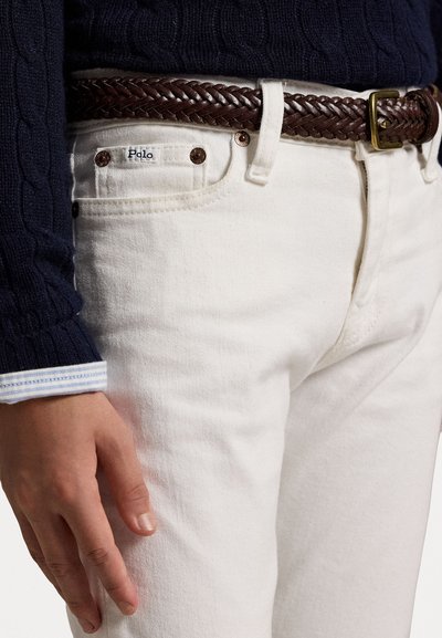 White denim jeans with a braided brown leather belt. The belt features a metal buckle and the pocket has a visible "Polo" label.