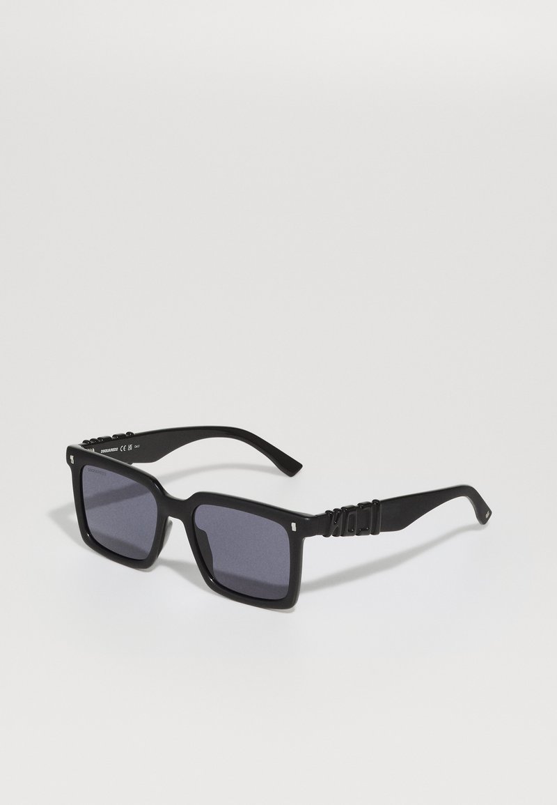 Black square sunglasses with dark lenses, thick plastic frames, and textured temple accents. Features a sleek, modern design.