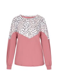 Hosszú ujjú ing, amelynek alsó része rózsaszín, míg a teteje mintás, fehér, bézs és szürke leopárd mintával, kerek nyakkivágással.