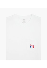 White short-sleeve t-shirt featuring a chest pocket with red and blue "Paris" embroidery. Simple round neck, cotton material, minimal texture.