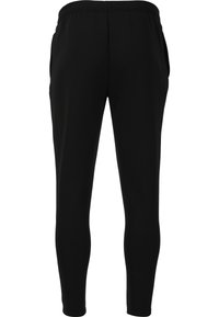 Svarta träningsbyxor i texturerad tyg med en åtsittande design, som har en stretchmidja och sidofickor.