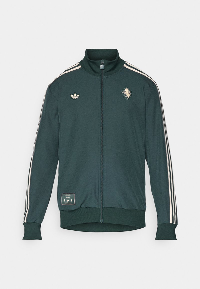 Grüne Zip-Jacke mit hohem Kragen, drei weißen Streifen an den Ärmeln, Logopatches, gerippten Bündchen und Saum, aus einem weichen Stoff gefertigt.