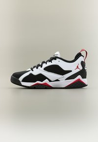 Κάτω αθλητικό παπούτσι σε μαύρο, λευκό και κόκκινο χρώμα με διακριτικά πλέγματα, μπροστινό δέσιμο με κορδόνια και κόκκινο λογότυπο Jumpman κοντά στη φτέρνα.