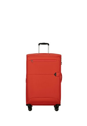 Red soft-shell suitcase with four black spinner wheels, a front zipper pocket, and an extended black handle.