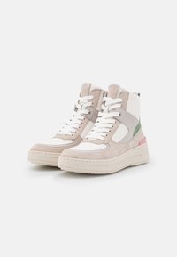 High-top sneakers in beige and white suede, featuring a padded ankle, white laces, a pink and green accent, and textured sole.