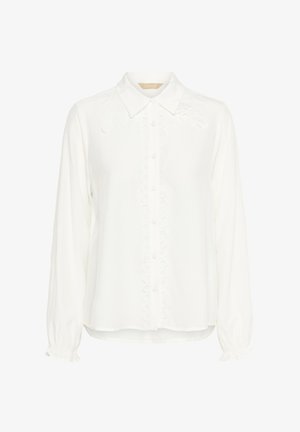 Bílá halenka s dlouhým rukávem, límečkem a zapínáním na knoflíky. Má přední výšivku a nařasené manžety pro zajímavý detail.