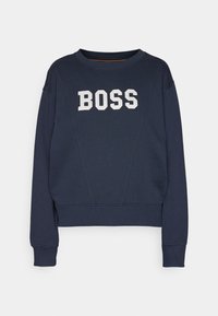 Sweat-shirt bleu marine à col rond, manches longues et lettres blanches en bloc formant "BOSS" au centre devant.