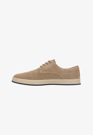 Scarpa da uomo beige in camoscio con lacci, tomaia traforata e suola bianca, mostrata di profilo su sfondo bianco.