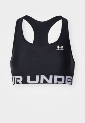Soutien-gorge de sport noir avec un design à dos nageur, fabriqué en tissu lisse. Présente une bande élastique blanche avec un logo au bas.