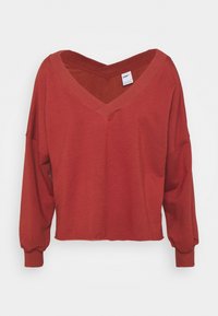 Felpa rossa accorciata con scollatura a V ampia e maniche lunghe e larghe. Realizzata in un tessuto morbido con una texture liscia. Presenta un'etichetta interna.