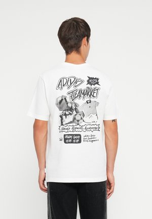 White t-shirt featuring a graphic design on the back with black text and illustrations related to Adidas, styled with casual fit and short sleeves.