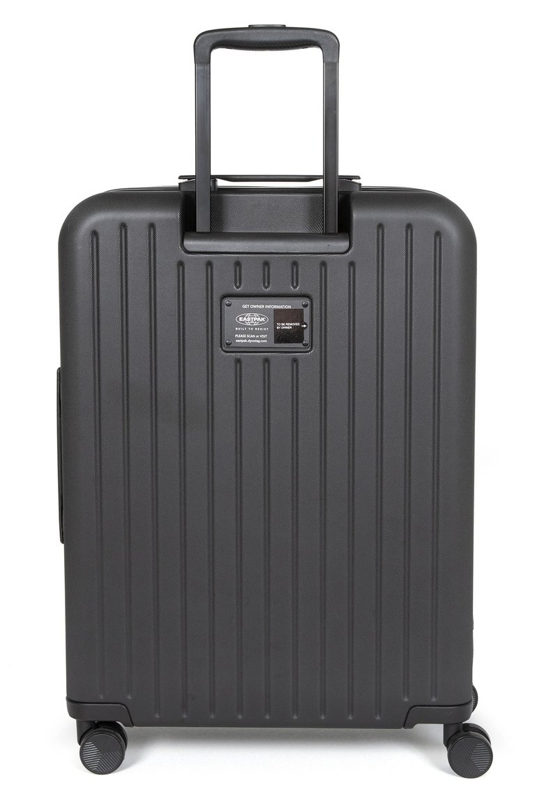 Valise rigide noire avec des rainures verticales, poignée rétractable et quatre roues. Comprend un espace pour une plaque nominale afin d'indiquer les informations du propriétaire.