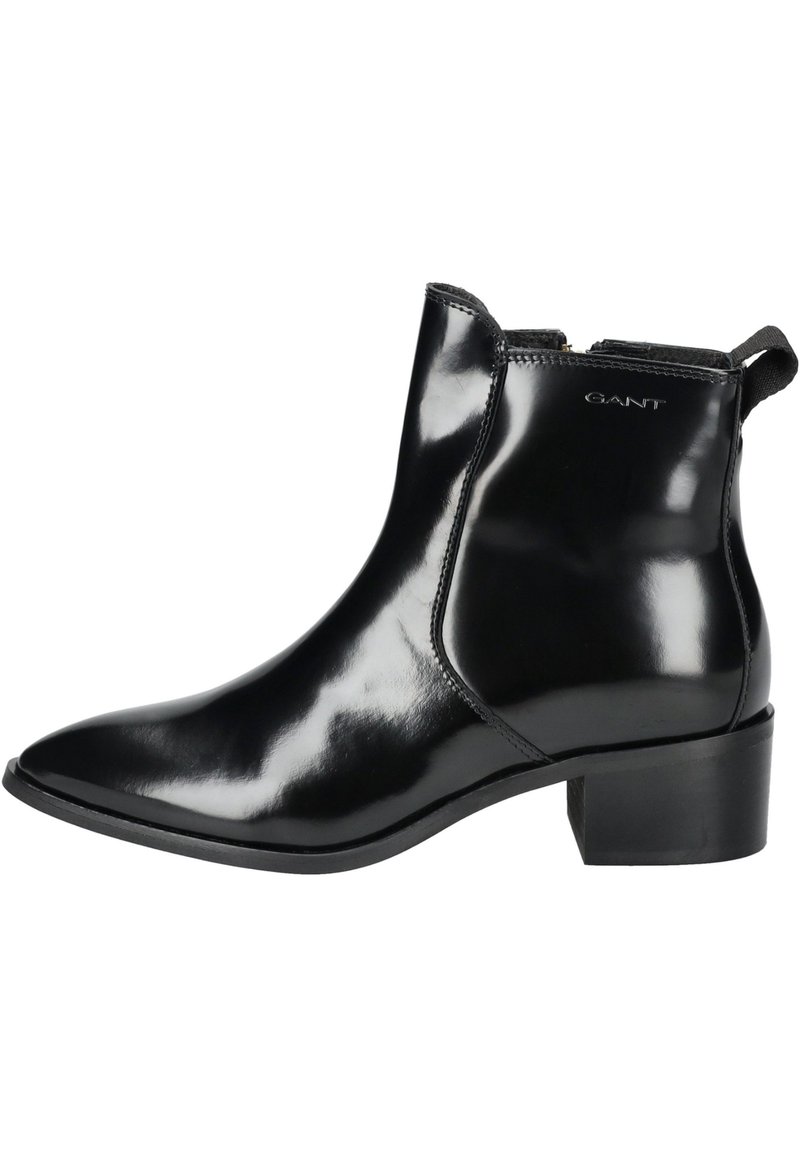 Schwarze Leder-Stiefeletten mit glänzendem Finish, spitz zulaufender Zehenpartie und niedrigem Blockabsatz. Verfügt über einen elastischen Einsatz und eine Zugschlaufe für einfachen Einstieg.