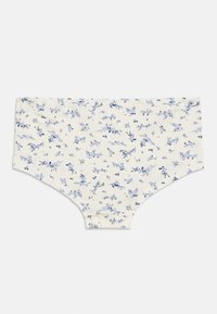 Culotte à motif floral en tissu crème, avec de petites fleurs bleues et des feuilles vertes. Coupe hipster classique avec une texture douce.