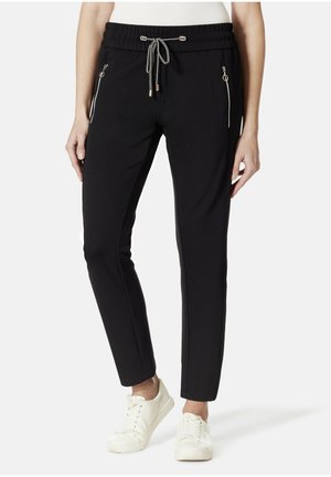 Schwarze Jogginghosen mit elastischem Bund, Kordelzug, seitlichen Reißverschlusstaschen und schmalem Schnitt. Stoff aus Baumwollmischung mit glatter Textur.