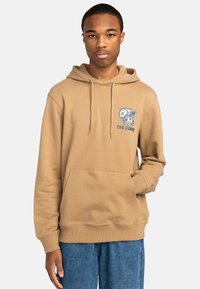 Tan hooded sweatshirt with a front pocket, featuring an embroidered graphic of a dog with a cap. Ribbed cuffs and hem, cotton material.