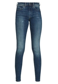 Smaljeans i denim med en mörkblå tvätt, med lätt blekningar, små slitna områden, fem fickor och midjeband med bälteshällor.